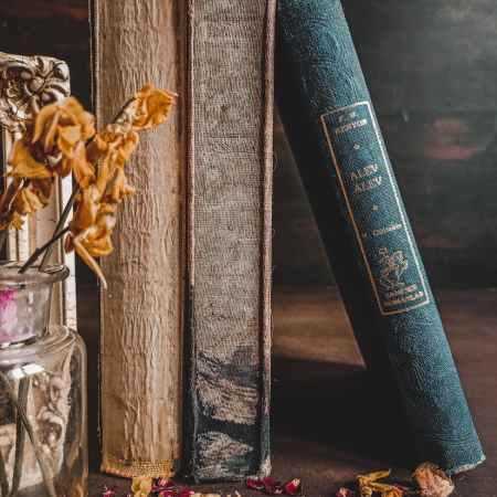 an image of old books and dried flowers.